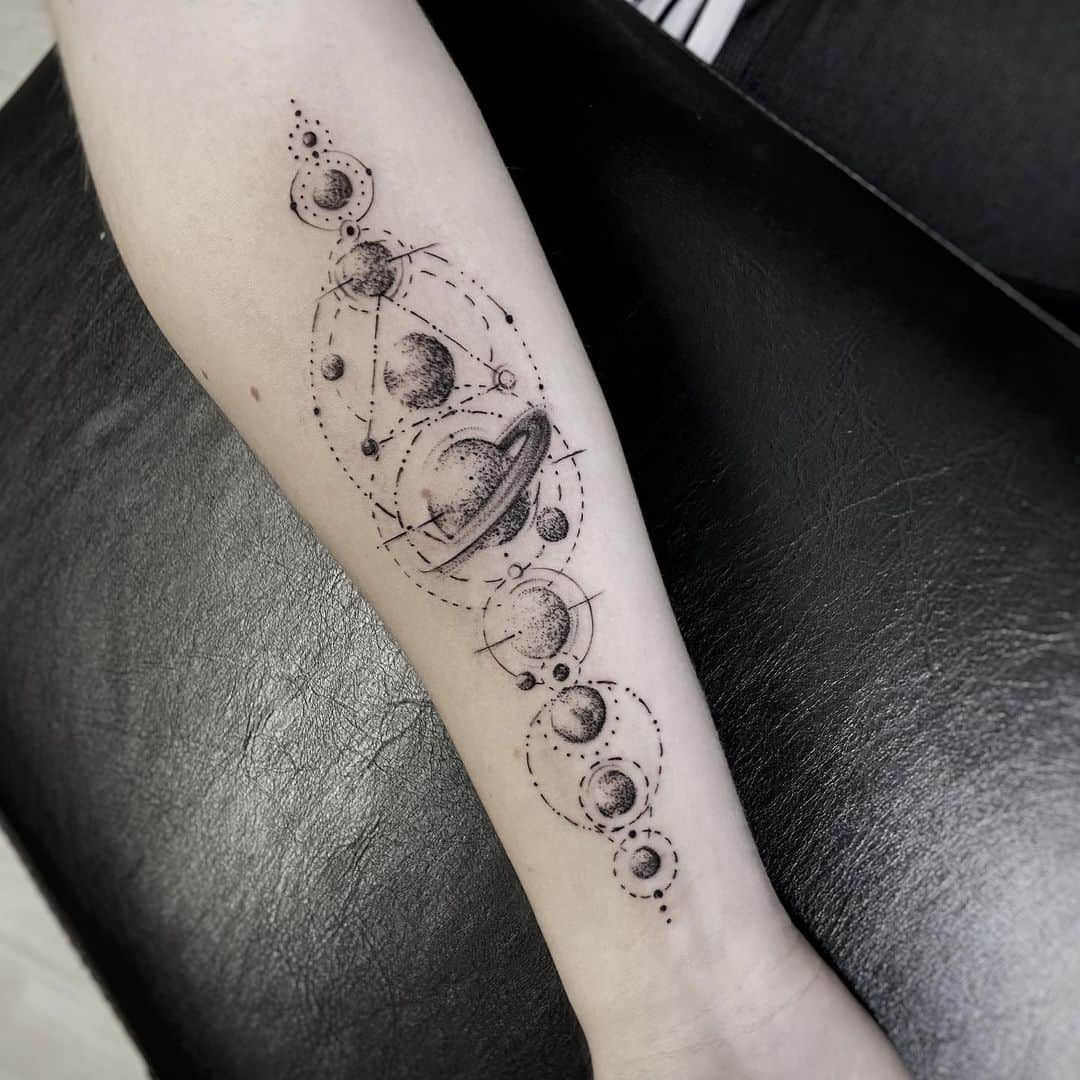 A close-up image displaying the intricate detail of a fine lines tattoo on a person's forearm. The tattoo features a delicate floral design with thin, precise lines, showcasing the artist's skill in creating detailed and subtle art on skin.