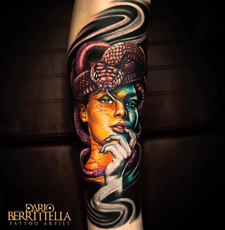 Surrealistic color tattoo of a ladyface and a snake on the leg
