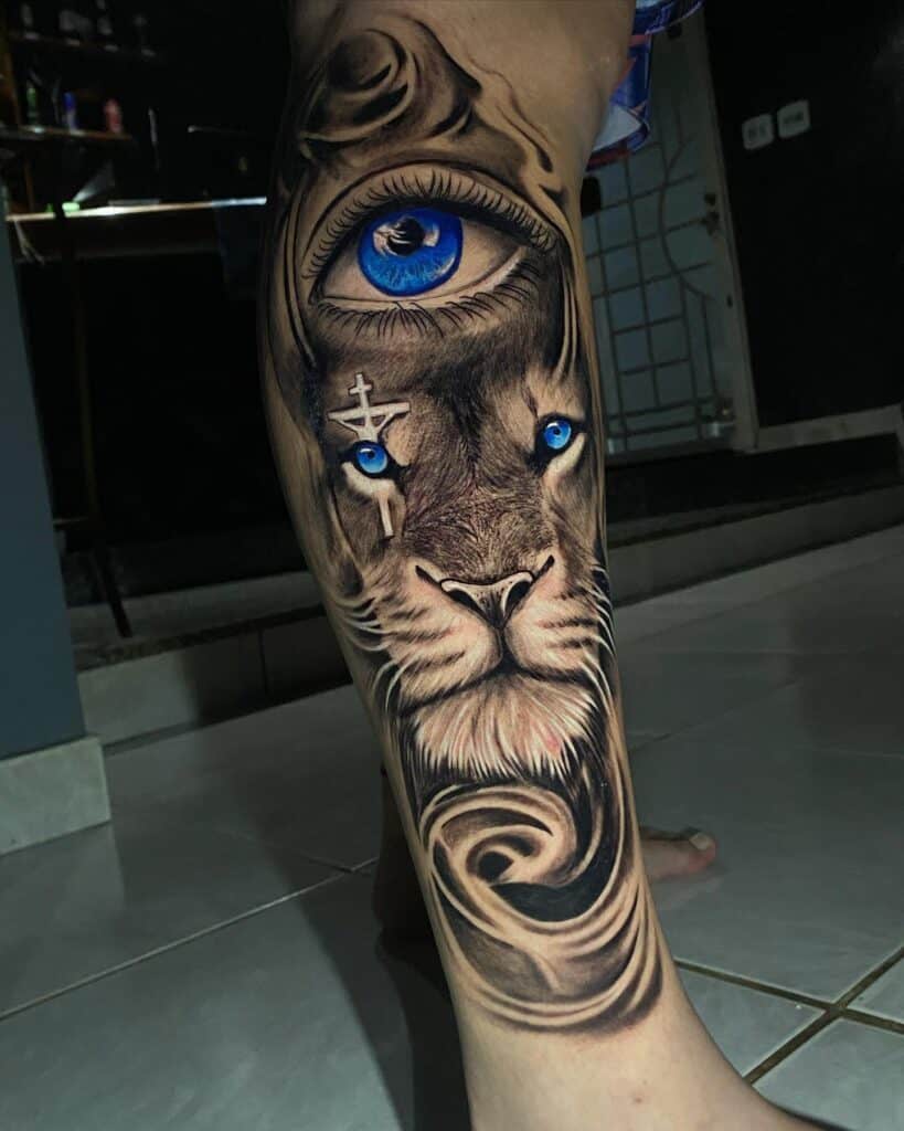 Lion face eye cross tattoo