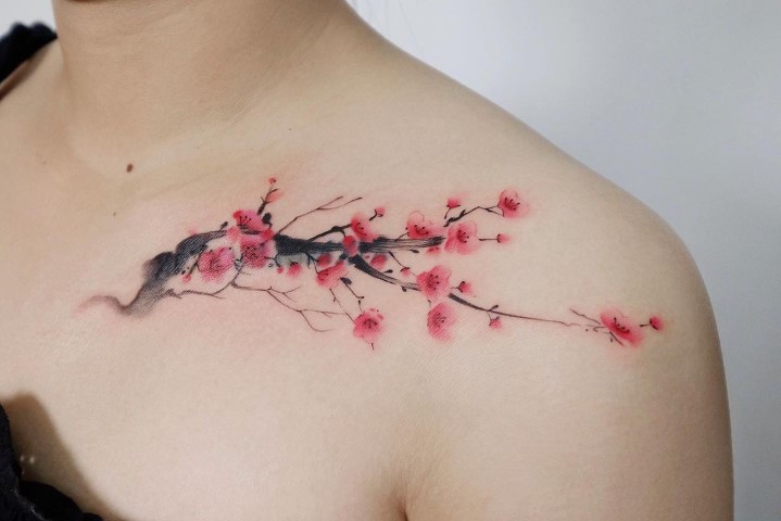 Illustrative cherry blossom tattoo on the left side