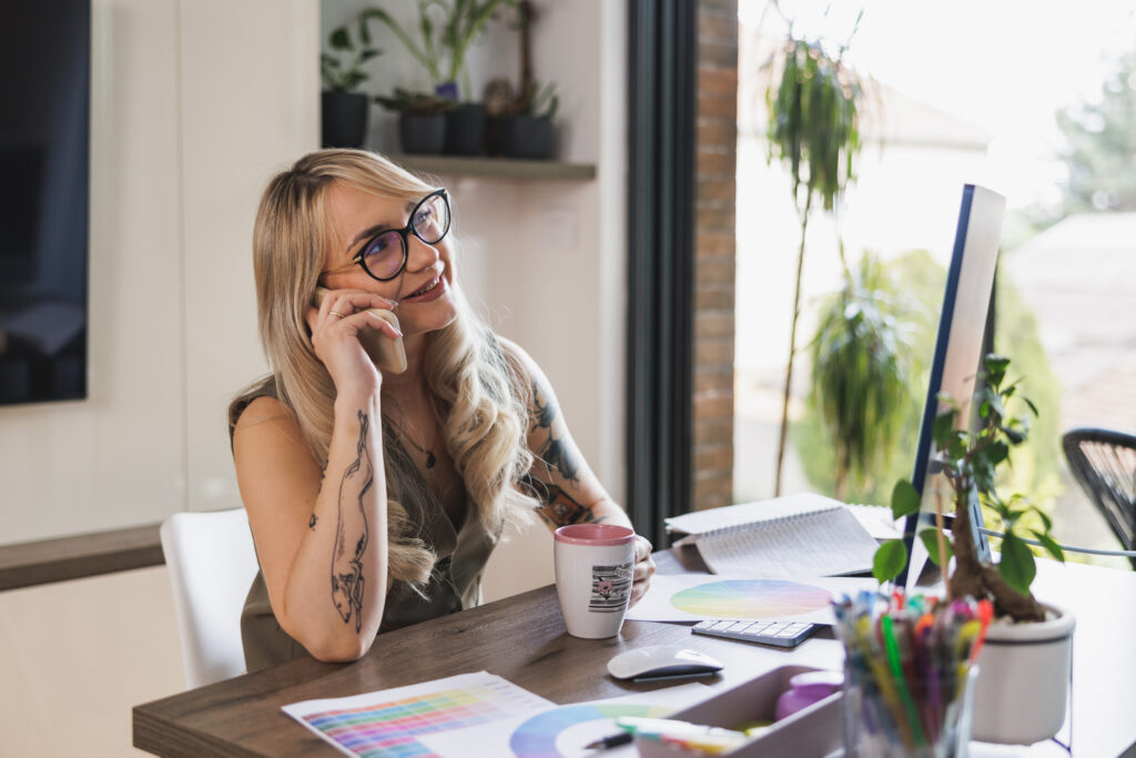 A tattoo manager on the phone speaking to a client.